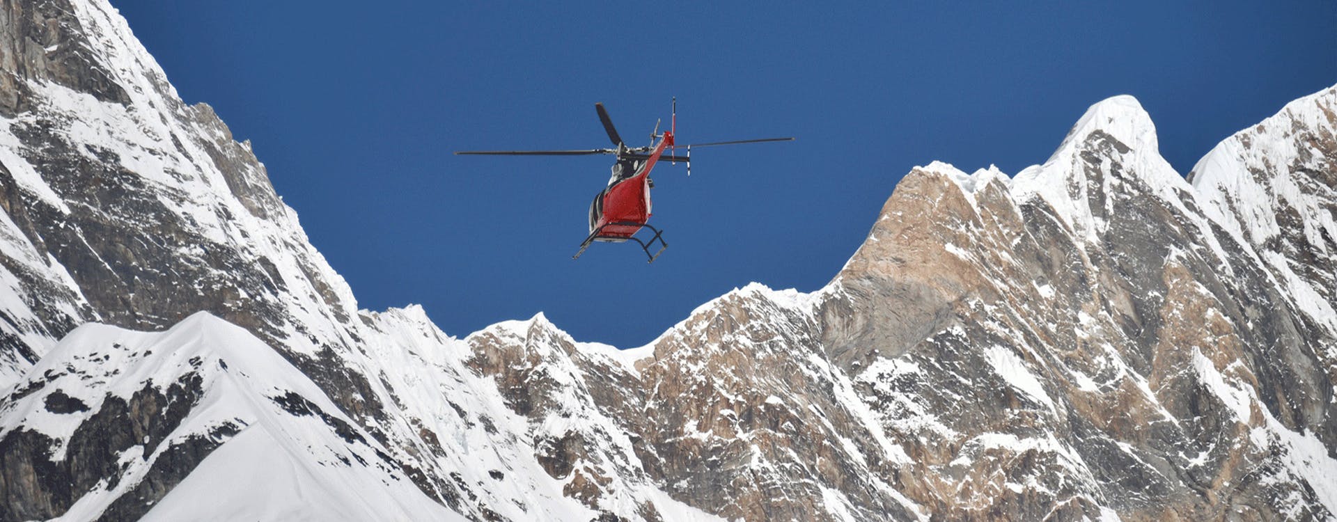 helicopter flying over mountain